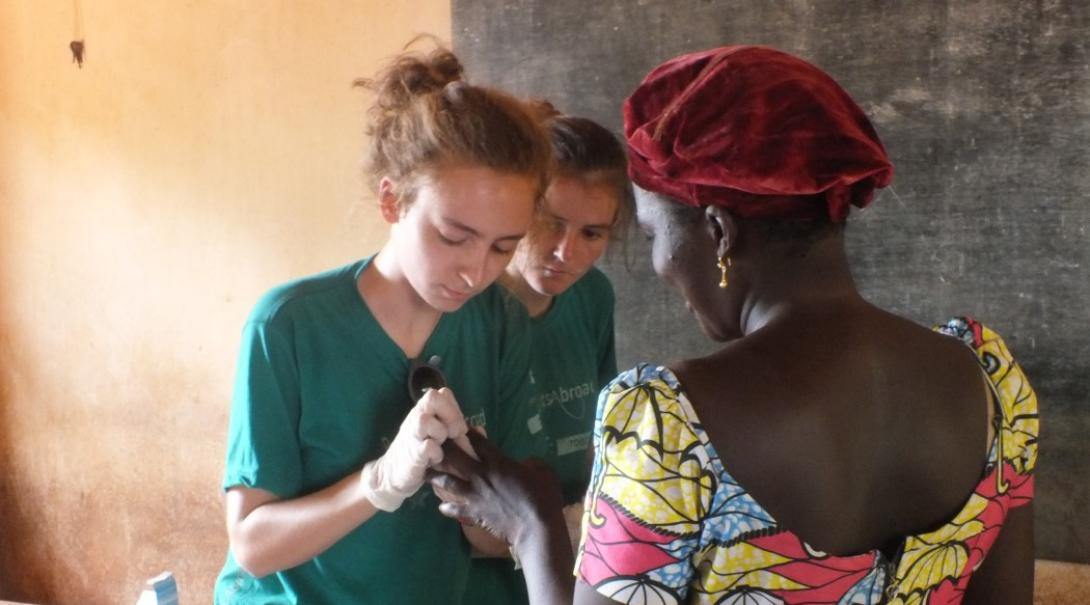 A nursing student examines a patient in Togo A nursing student examines a patient in Togo